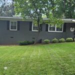 a house with a lawn and a fence